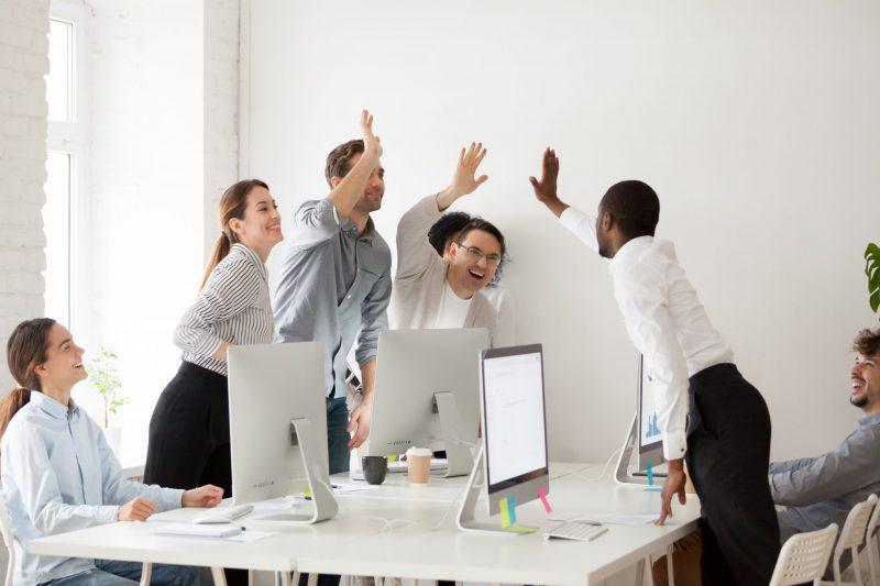 Happy Multi Ethnic Employees Sales Team Giving High Five Togethe